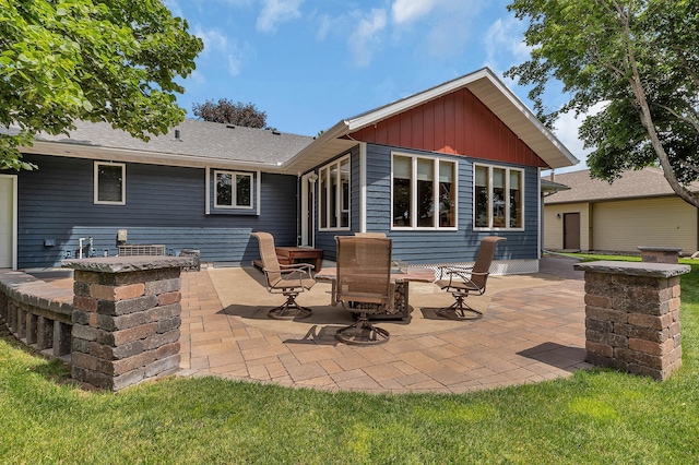 1213 4 1/2 Ave N, Sauk Rapids, MN 56379 - rear view of property with a patio area and board and batten siding