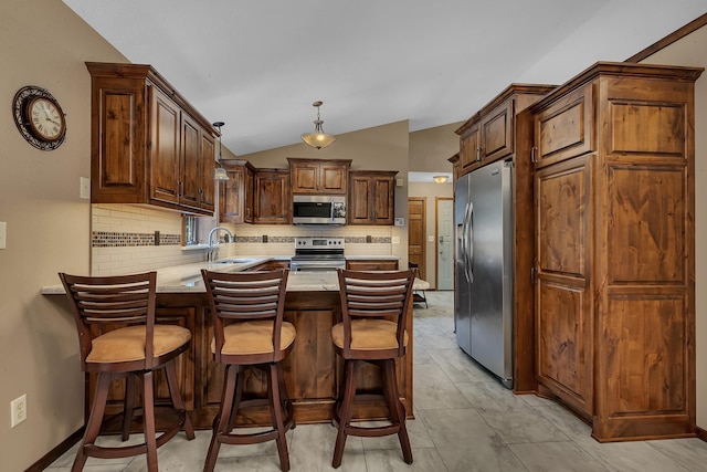 1213 4 1/2 Ave N, Sauk Rapids, MN 56379 - kitchen with stainless steel appliances, a peninsula, decorative backsplash, vaulted ceiling, and hanging light fixtures