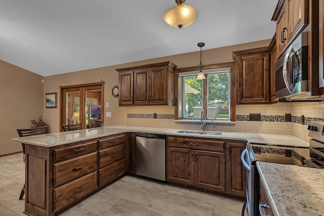 1213 4 1/2 Ave N, Sauk Rapids, MN 56379 - kitchen featuring stainless steel appliances, a peninsula, tasteful backsplash, pendant lighting, and vaulted ceiling
