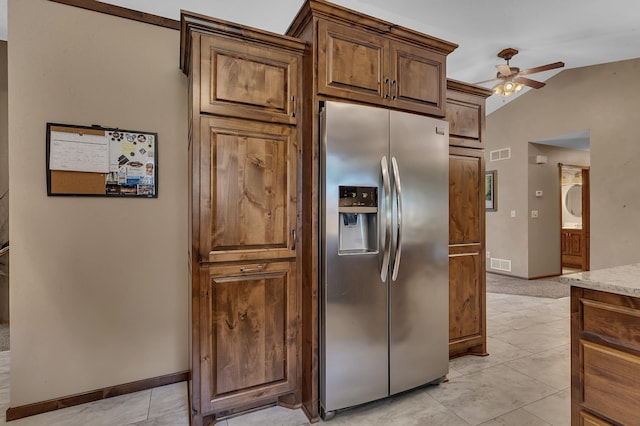 1213 4 1/2 Ave N, Sauk Rapids, MN 56379 - kitchen featuring stainless steel fridge with ice dispenser, a ceiling fan, lofted ceiling, light tile patterned flooring, and light stone countertops