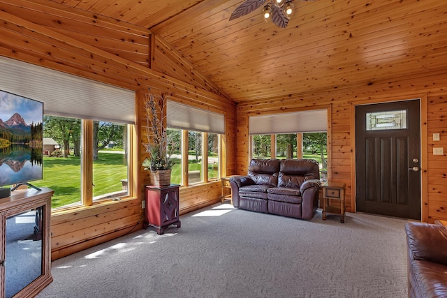 1213 4 1/2 Ave N, Sauk Rapids, MN 56379 - carpeted living area featuring vaulted ceiling, healthy amount of natural light, wooden walls, and a ceiling fan