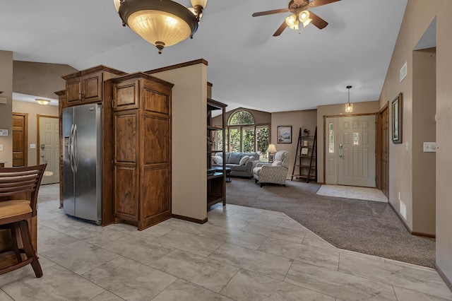 1213 4 1/2 Ave N, Sauk Rapids, MN 56379 - kitchen featuring stainless steel refrigerator with ice dispenser, lofted ceiling, ceiling fan, light colored carpet, and open floor plan