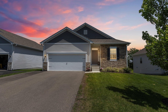 256 16th Ave SE, Lonsdale, MN 55046 - view of front of house with driveway, stone siding, a front lawn, and a garage