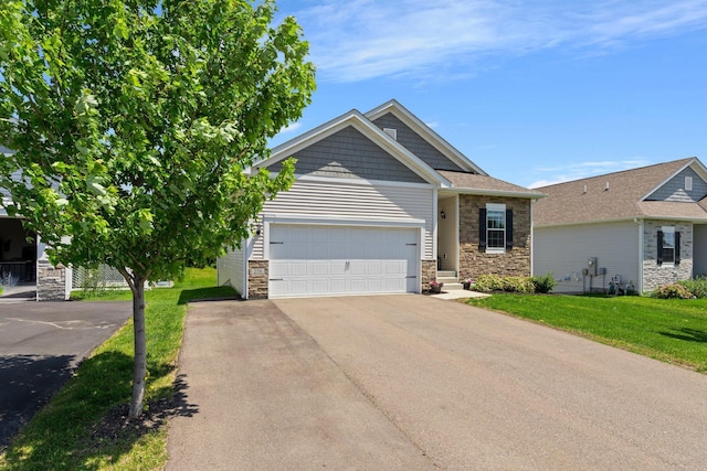 256 16th Ave SE, Lonsdale, MN 55046 - view of front of property with stone siding, a garage, a front yard, and driveway