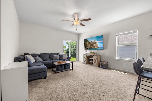 256 16th Ave SE, Lonsdale, MN 55046 - carpeted living area featuring ceiling fan and baseboards