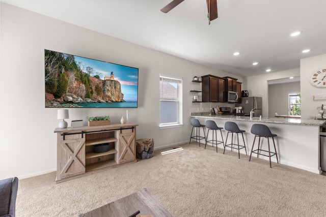 256 16th Ave SE, Lonsdale, MN 55046 - living area featuring light colored carpet, ceiling fan, and recessed lighting