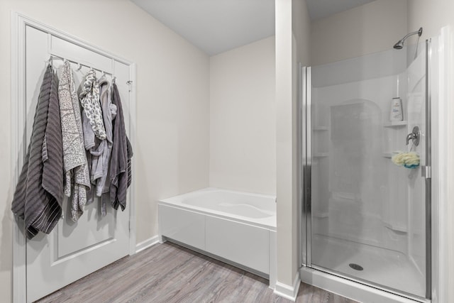 256 16th Ave SE, Lonsdale, MN 55046 - full bath featuring a stall shower, wood finished floors, and a bath