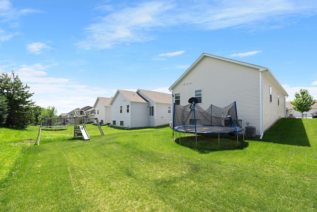 256 16th Ave SE, Lonsdale, MN 55046 - back of property with a trampoline, a lawn, and a playground