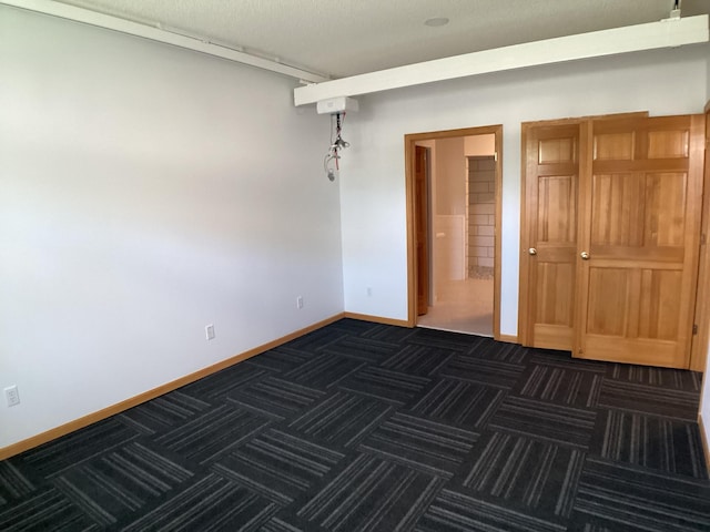 2009 Stahlke Way Unit 15, Chaska, MN 55318 - spare room featuring dark carpet and baseboards