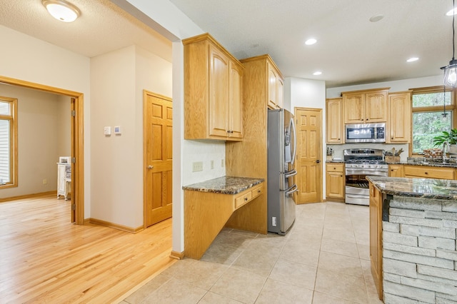 18250 221st Ave NW, Big Lake, MN 55309 - kitchen featuring stainless steel appliances, dark stone countertops, recessed lighting, and light wood finished floors