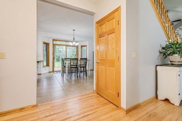 18250 221st Ave NW, Big Lake, MN 55309 - corridor with a chandelier, light wood-style flooring, and stairway
