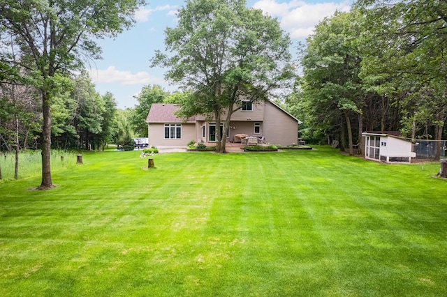 18250 221st Ave NW, Big Lake, MN 55309 - view of grassy yard with an outdoor structure and a deck
