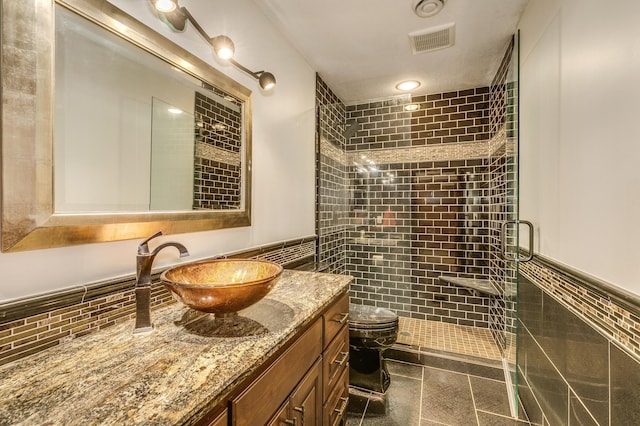 18250 221st Ave NW, Big Lake, MN 55309 - full bathroom with tile walls, a stall shower, vanity, and a wainscoted wall