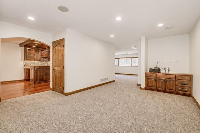 18250 221st Ave NW, Big Lake, MN 55309 - spare room featuring carpet flooring, a dry bar, recessed lighting, and arched walkways