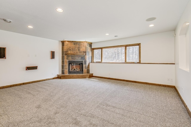 18250 221st Ave NW, Big Lake, MN 55309 - unfurnished living room with carpet floors, recessed lighting, and a tiled fireplace