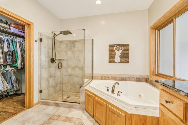 18250 221st Ave NW, Big Lake, MN 55309 - full bathroom featuring a whirlpool tub, a stall shower, a spacious closet, and recessed lighting