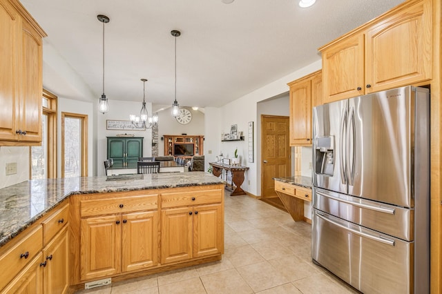 18250 221st Ave NW, Big Lake, MN 55309 - kitchen with stainless steel fridge, a peninsula, a fireplace, stone countertops, and light tile patterned floors