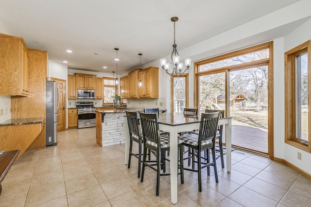 18250 221st Ave NW, Big Lake, MN 55309 - dining room with a chandelier, light tile patterned floors, and recessed lighting