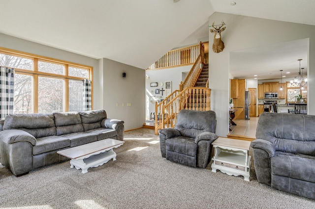 18250 221st Ave NW, Big Lake, MN 55309 - living area with stairway, light colored carpet, high vaulted ceiling, and a chandelier