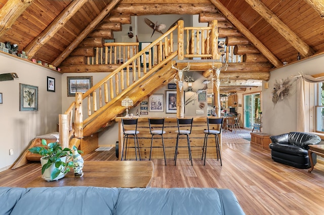15015 Held Cir, Cold Spring, MN 56320 - bar featuring rustic walls, a wooden ceiling with exposed beams, hardwood / wood-style flooring, high vaulted ceiling, and stairs