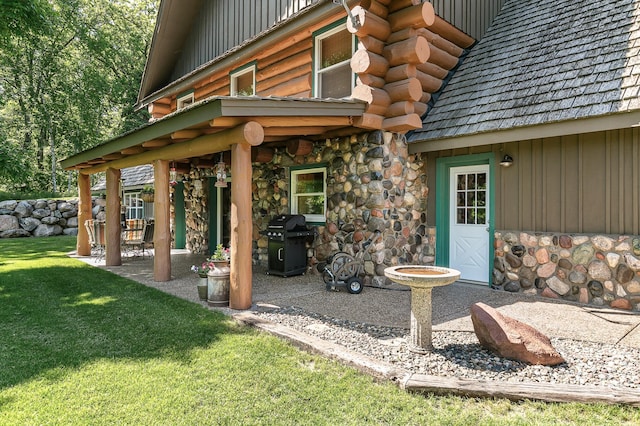 15015 Held Cir, Cold Spring, MN 56320 - property entrance with a yard, stone siding, and log siding