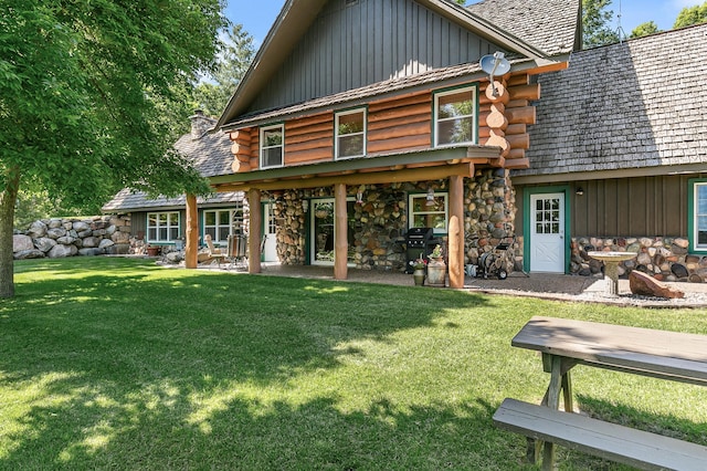 15015 Held Cir, Cold Spring, MN 56320 - back of property featuring board and batten siding, log siding, a yard, a chimney, and stone siding