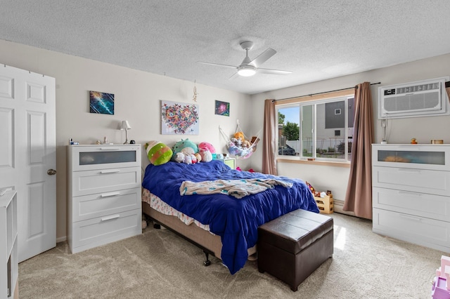 333 8th St SE Unit 120, Minneapolis, MN 55414 - bedroom featuring light colored carpet, a wall mounted air conditioner, a textured ceiling, and ceiling fan