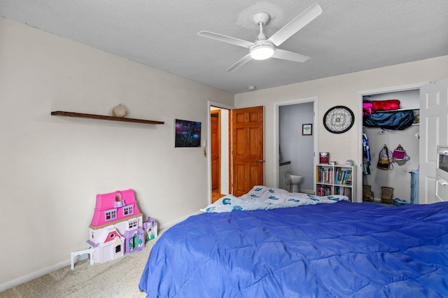 333 8th St SE Unit 120, Minneapolis, MN 55414 - carpeted bedroom with a textured ceiling, ceiling fan, ensuite bathroom, and a closet