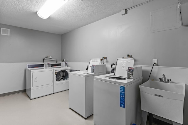 333 8th St SE Unit 120, Minneapolis, MN 55414 - communal laundry room featuring separate washer and dryer and a textured ceiling