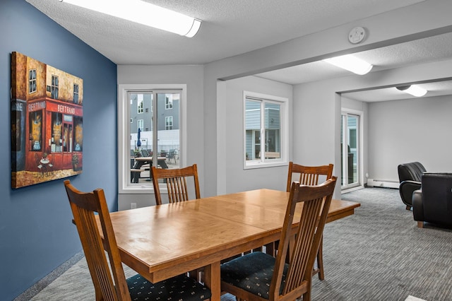 333 8th St SE Unit 120, Minneapolis, MN 55414 - dining area featuring carpet and a baseboard heating unit