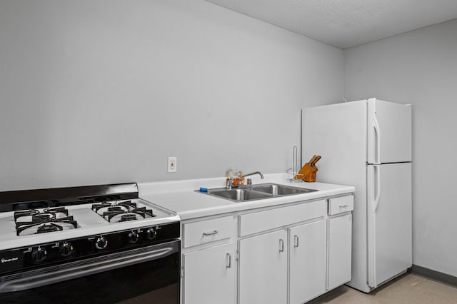 333 8th St SE Unit 120, Minneapolis, MN 55414 - kitchen featuring gas range oven, freestanding refrigerator, light countertops, white cabinets, and a textured ceiling