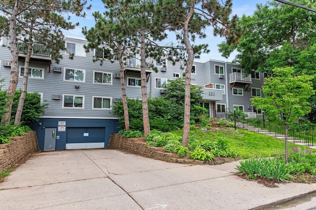 333 8th St SE Unit 120, Minneapolis, MN 55414 - view of building exterior with an attached garage and concrete driveway
