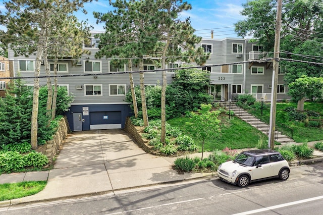 333 8th St SE Unit 120, Minneapolis, MN 55414 - view of property with a garage and concrete driveway