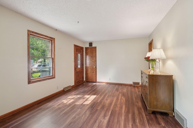 7507 Blaisdell Ave, Richfield, MN 55423 - empty room with dark wood-style floors and a textured ceiling