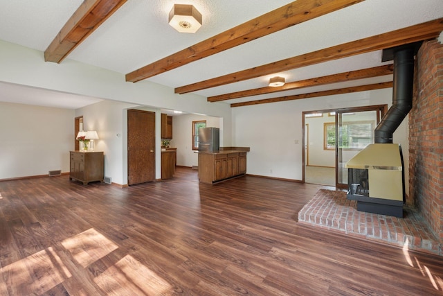 7507 Blaisdell Ave, Richfield, MN 55423 - living area featuring a wood stove, dark wood-style floors, and beamed ceiling
