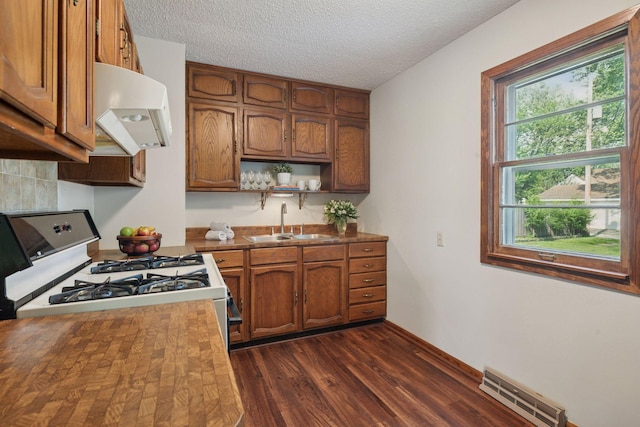 7507 Blaisdell Ave, Richfield, MN 55423 - kitchen with white gas range, ventilation hood, brown cabinets, a textured ceiling, and open shelves