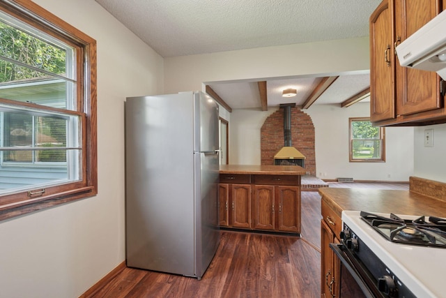 7507 Blaisdell Ave, Richfield, MN 55423 - kitchen featuring freestanding refrigerator, range hood, dark wood finished floors, brown cabinets, and a textured ceiling
