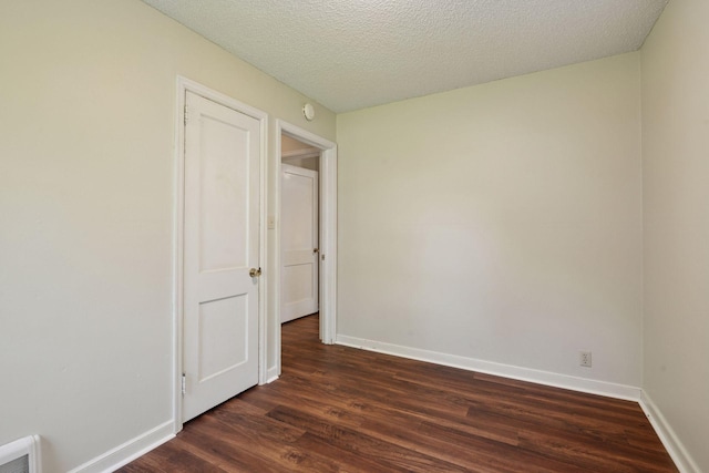 7507 Blaisdell Ave, Richfield, MN 55423 - unfurnished bedroom featuring dark wood-style flooring and a textured ceiling