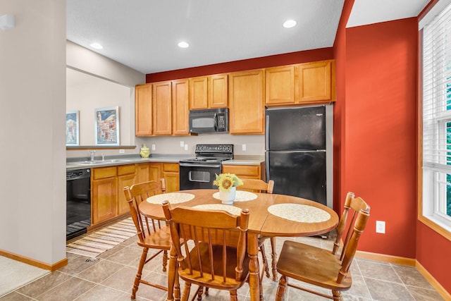 4107 Scott Ave N, Robbinsdale, MN 55422 - kitchen with black appliances, light countertops, plenty of natural light, recessed lighting, and light tile patterned floors