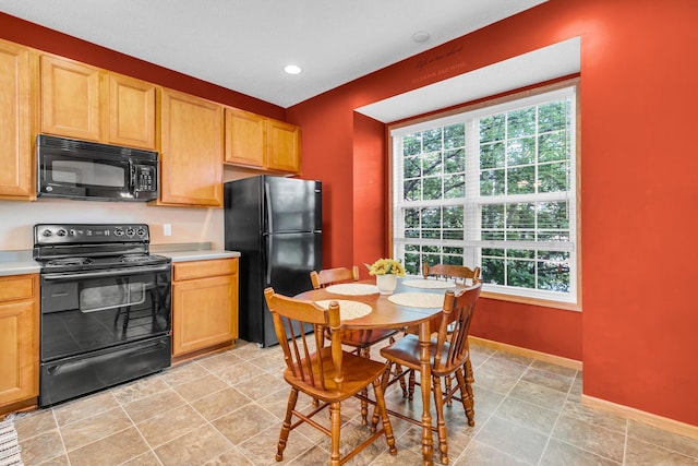4107 Scott Ave N, Robbinsdale, MN 55422 - kitchen with black appliances, plenty of natural light, light countertops, and recessed lighting