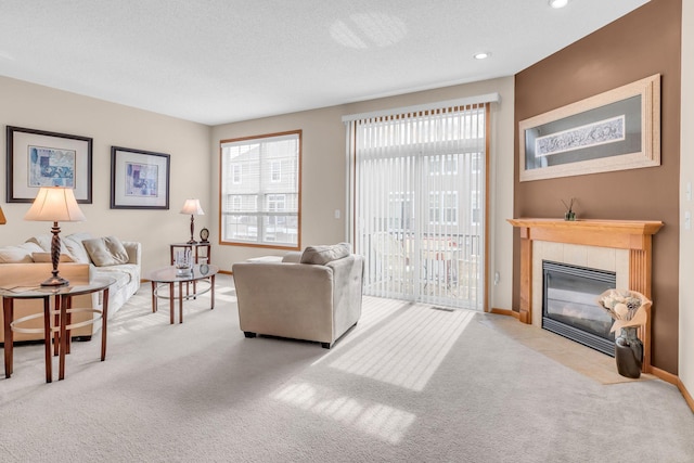4107 Scott Ave N, Robbinsdale, MN 55422 - carpeted living area with a tiled fireplace and recessed lighting