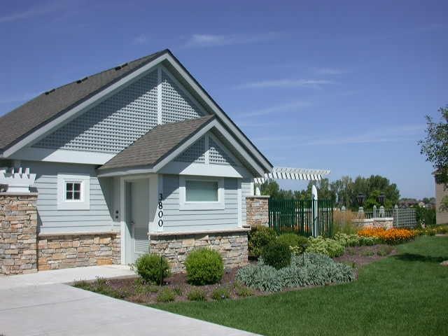 10794 Hawthorn Trl Unit A, Woodbury, MN 55129 - view of side of home with stone siding
