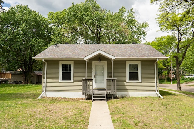 3555 Queen Ave N, Minneapolis, MN 55412 - bungalow with a front lawn and a shingled roof