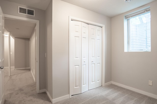 3555 Queen Ave N, Minneapolis, MN 55412 - unfurnished bedroom featuring light colored carpet and a closet