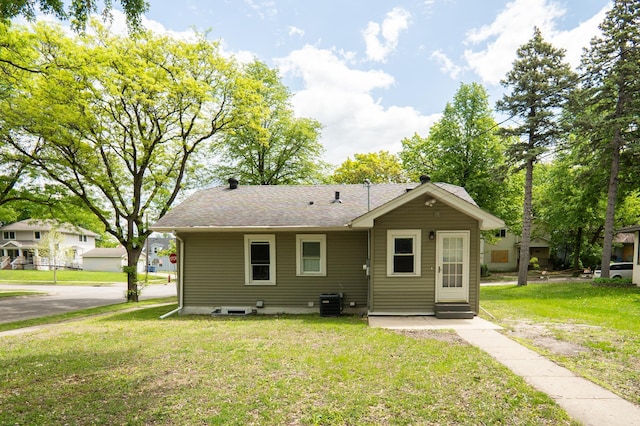 3555 Queen Ave N, Minneapolis, MN 55412 - rear view of house with a lawn and roof with shingles