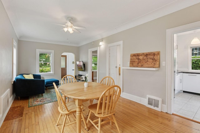 5321 39th Ave S, Minneapolis, MN 55417 - dining area featuring light wood-style flooring, plenty of natural light, and arched walkways