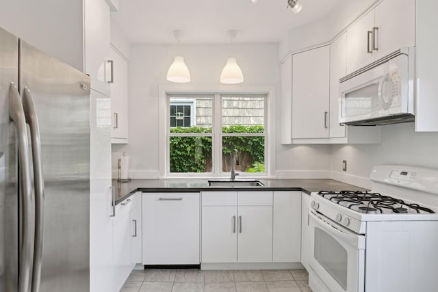 5321 39th Ave S, Minneapolis, MN 55417 - kitchen featuring white appliances, dark countertops, white cabinets, and hanging light fixtures