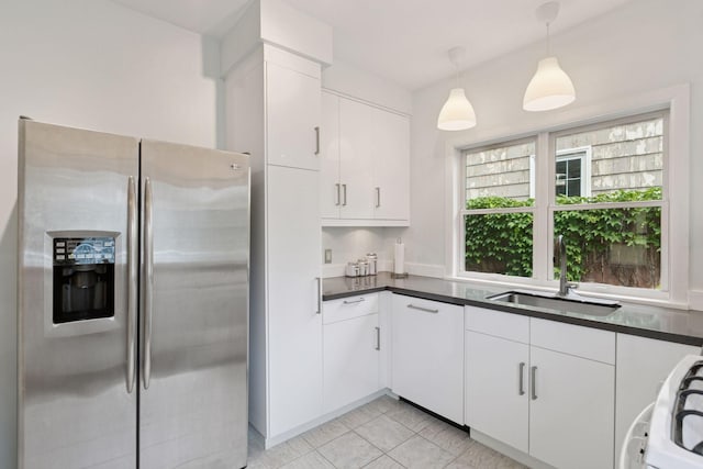 5321 39th Ave S, Minneapolis, MN 55417 - kitchen with stainless steel fridge, dark countertops, white cabinets, and hanging light fixtures