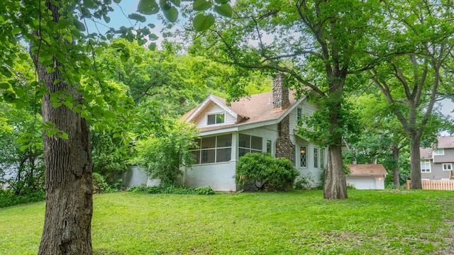 3672 Snelling Ave N, Arden Hills, MN 55112 - view of home's exterior featuring a sunroom, a chimney, and a lawn