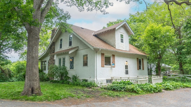 3672 Snelling Ave N, Arden Hills, MN 55112 - view of side of property featuring a shingled roof and stucco siding